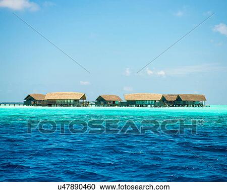 Stock Image - Water villas above turquoise ocean, Maldives. Fotosearch