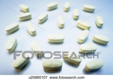 Stock Photo - White oval pills. Fotosearch