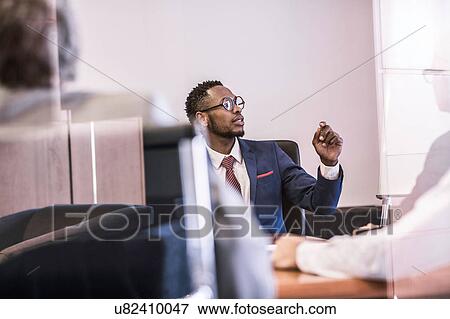 Window view of businessman questioning in board meeting View Large Photo Image Stock Photo - Window view of businessman questioning in board meeting. Fotosearch