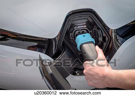 Woman charging electric car, close up detail View Large Photo Image Stock Image - Woman charging electric car, close up detail. Fotosearch