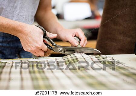 Woman cutting fabric in leather jacket manufacturers, close-up View Large Photo Image Stock Photo - Woman cutting fabric in leather jacket manufacturers, close-up. Fotosearch