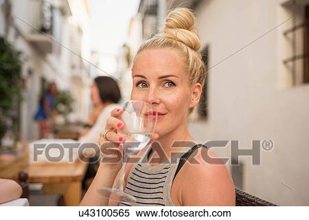 Woman drinking water at sidewalk cafe, Altea, Alicante Province, Spain View Large Photo Image Stock Photography - Woman drinking water at sidewalk cafe, Altea, Alicante Province, Spain. Fotosearch