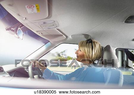 Stock Photography - Woman driving electric car. Fotosearch