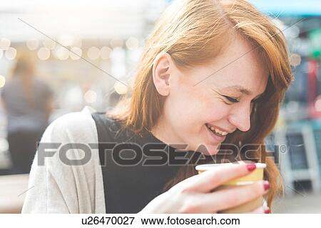Woman holding disposable cup smiling, London, UK View Large Photo Image Stock Photo - Woman holding disposable cup smiling, London, UK. Fotosearch