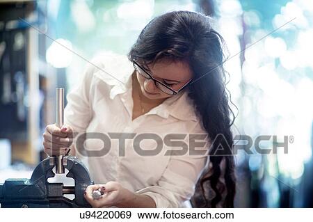 Woman in bicycle repair shop operative vice grip View Large Photo Image Stock Photo - Woman in bicycle repair shop operative vice grip. Fotosearch