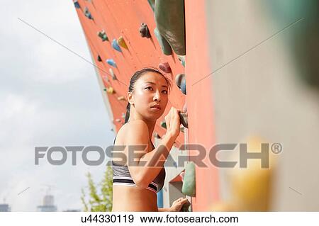 Woman on climbing wall View Large Photo Image Stock Photo - Woman on climbing wall. Fotosearch