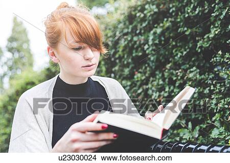 Picture - Woman reading book, London, UK. Fotosearch