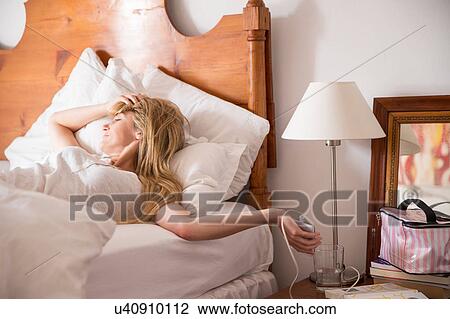 Woman waking up in bed View Large Photo Image Stock Image - Woman waking up in bed. Fotosearch