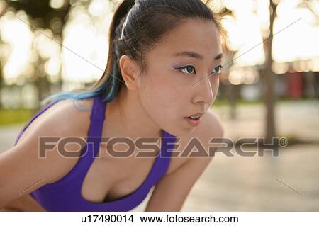Picture - Woman wearing crop top looking away. Fotosearch