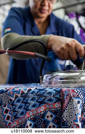 Worker ironing dress in garment factory View Large Photo Image Stock Photo - Worker ironing dress in garment factory. Fotosearch