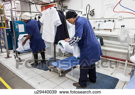 Workers ironing shirt in garment factory View Large Photo Image Stock Photo - Workers ironing shirt in garment factory. Fotosearch