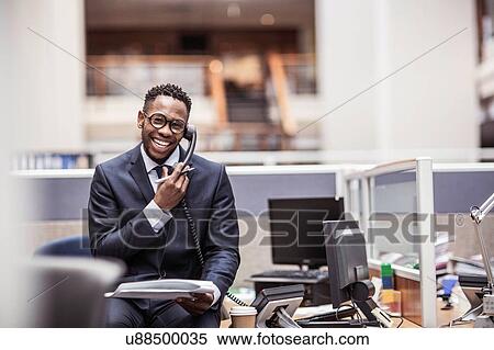 Young businessman getting update on landline telephone in office View Large Photo Image Stock Photography - Young businessman getting update on landline telephone in office. Fotosearch