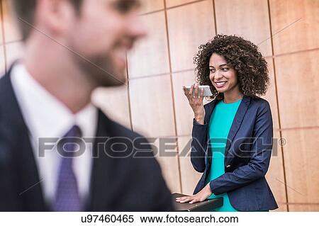 Young businesswoman talking on smartphone in office View Large Photo Image Stock Photography - Young businesswoman talking on smartphone in office. Fotosearch