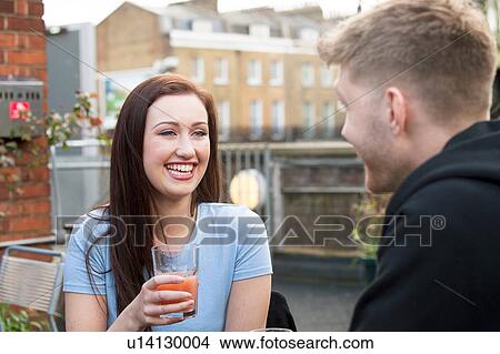 Picture - Young couple chatting on terrace. Fotosearch