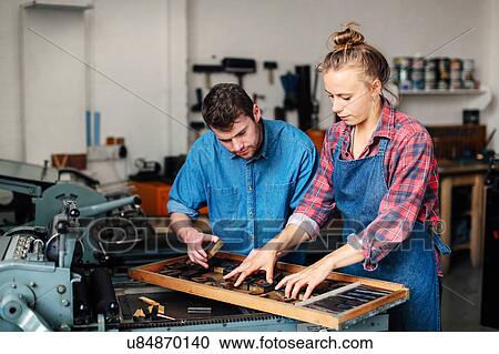 Young craftsman and craftswoman looking at letterpress letters in book arts workshop View Large Photo Image Stock Image - Young craftsman and craftswoman looking at letterpress letters in book arts workshop. Fotosearch