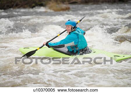 Young female kayaker paddling River Dee rapids View Large Photo Image Stock Photography - Young female kayaker paddling River Dee rapids. Fotosearch