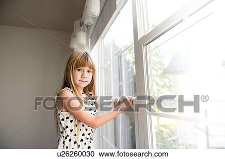 Young girl looking away from window View Large Photo Image Stock Image - Young girl looking away from window. Fotosearch