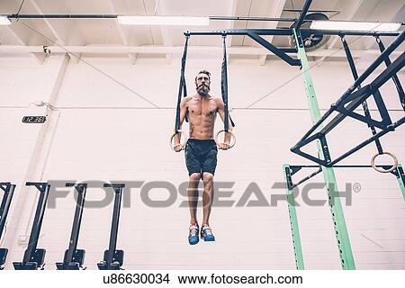 Young male cross trainer training on gymnastic rings View Large Photo Image Picture - Young male cross trainer training on gymnastic rings. Fotosearch