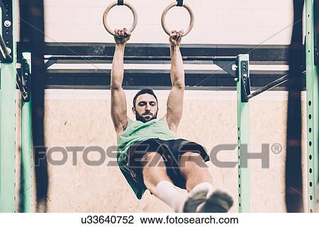Young male cross trainer training on exercise rings in gym View Large Photo Image Stock Image - Young male cross trainer training on exercise rings in gym. Fotosearch