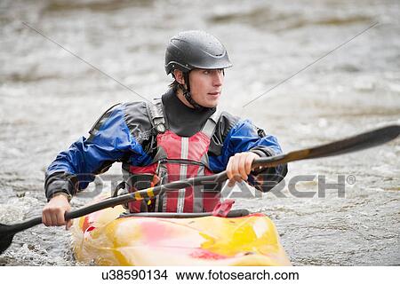 Young male kayaker paddling River Dee rapids View Large Photo Image Picture - Young male kayaker paddling River Dee rapids. Fotosearch