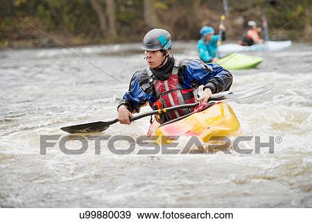 Young male kayaker paddling River Dee rapids View Large Photo Image Stock Photo - Young male kayaker paddling River Dee rapids. Fotosearch