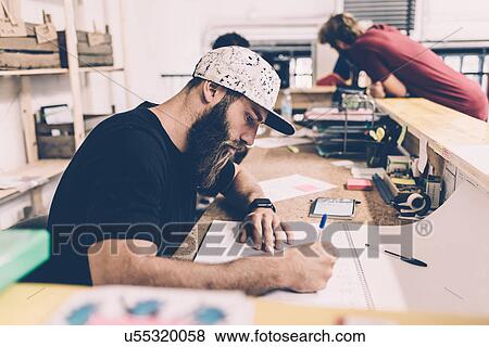 Young man writing on calendar at gym reception desk View Large Photo Image Stock Photo - Young man writing on calendar at gym reception desk. Fotosearch