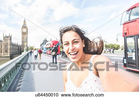 Young woman taking selfie, Houses of parliament and Big Ben in background, London, England View Large Photo Image Stock Image - Young woman taking selfie, Houses of parliament and Big Ben in background, London, England. Fotosearch