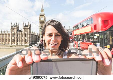 Young woman taking selfie with smartphone, Houses of parliament and Big Ben in background View Large Photo Image Stock Photography - Young woman taking selfie with smartphone, Houses of parliament and Big Ben in background. Fotosearch