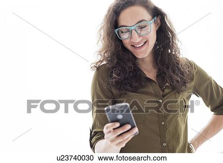 Stock Image - Young woman using smart phone. Fotosearch