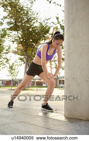 Young woman wearing spandex stretching leg View Large Photo Image Stock Photography - Young woman wearing spandex stretching leg. Fotosearch