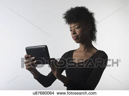 Picture - Young woman with digital tablet. Fotosearch