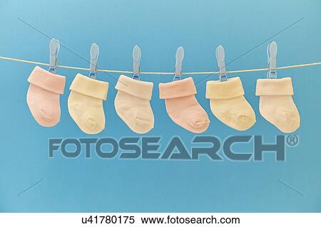 Stock Photography - Baby socks hanging on washing line. Fotosearch