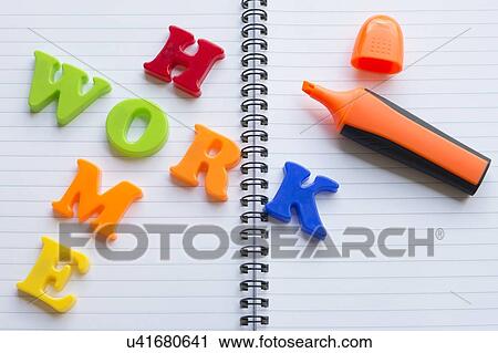Stock Image - Colourful letters on notebook spelling homework. Fotosearch