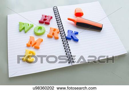 Stock Image - Colourful letters on notebook spelling homework. Fotosearch