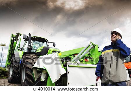 Farmer and tractor View Large Photo Image Picture - Farmer and tractor. Fotosearch