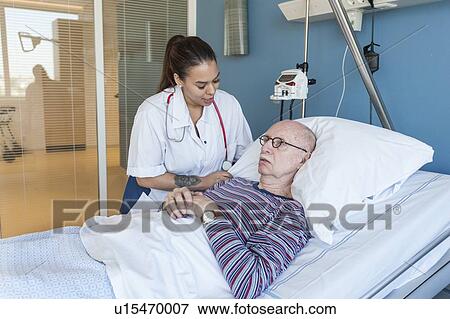 Female nurse reassuring male patient View Large Photo Image Stock Photo - Female nurse reassuring male patient. Fotosearch