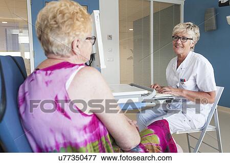 Stock Photo - Female patient talking to doctor. Fotosearch