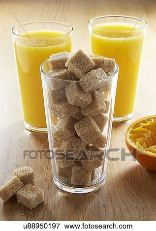 Freshly squeezed orange juice and sugar cubes View Large Photo Image Stock Photo - Freshly squeezed orange juice and sugar cubes. Fotosearch