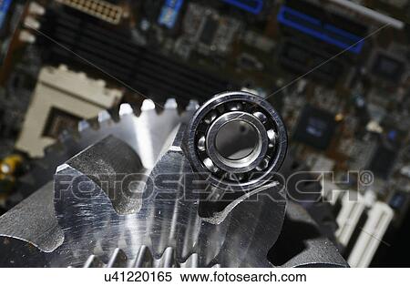Stock Photography - Gears and cogs with computer parts. Fotosearch
