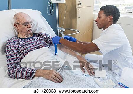 Male nurse examining senior man View Large Photo Image Stock Photo - Male nurse examining senior man. Fotosearch