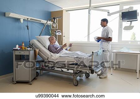 Male nurse talking to senior man View Large Photo Image Picture - Male nurse talking to senior man. Fotosearch