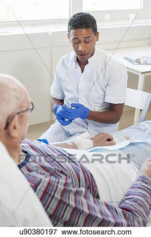 Male nurse talking to senior man View Large Photo Image Stock Photo - Male nurse talking to senior man. Fotosearch