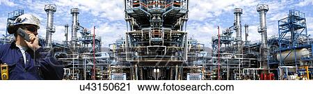 Stock Image - Man working at petrochemical plant. Fotosearch