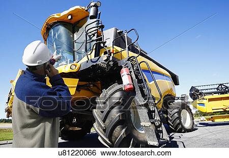Mechanic on cell phone View Large Photo Image Stock Photograph - Mechanic on cell phone. Fotosearch