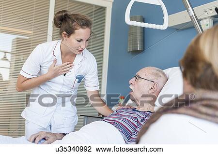 Stock Image - Nurse talking to senior man. Fotosearch