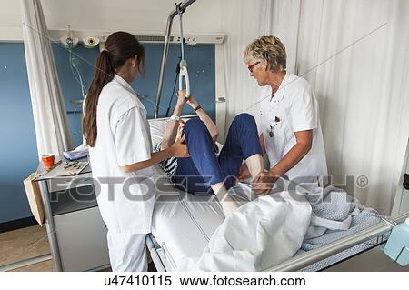 Stock Photography - Nurses assisting Patient. Fotosearch