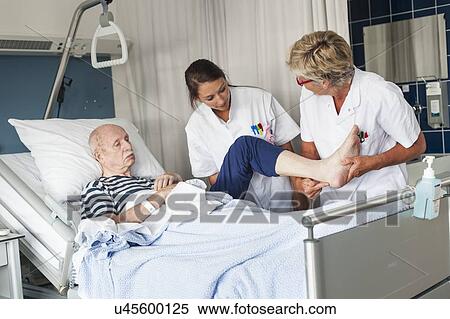 Stock Photography - Nurses examining Patient. Fotosearch