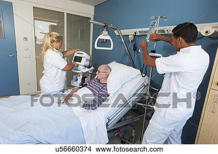 Picture - Nurses working with senior man. Fotosearch