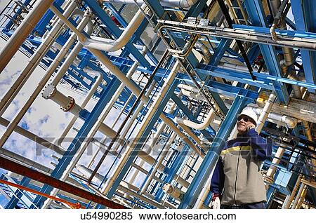 Stock Photography - Oil and gas worker at refinery. Fotosearch