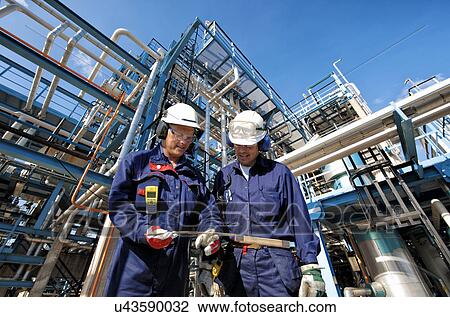 Oil and gas workers at refinery View Large Photo Image Stock Image - Oil and gas workers at refinery. Fotosearch